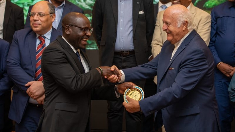 Investment, Industry and Trade deputy Minister Exaud Kigahe (left) receives an appreciation award from Mkinga Economic Zone project chairman Nauel All Assad
